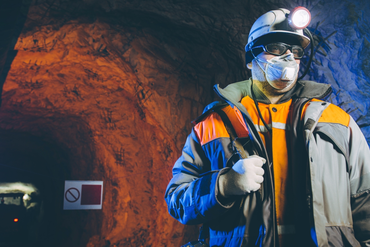 worker in protective gear underground in a mine