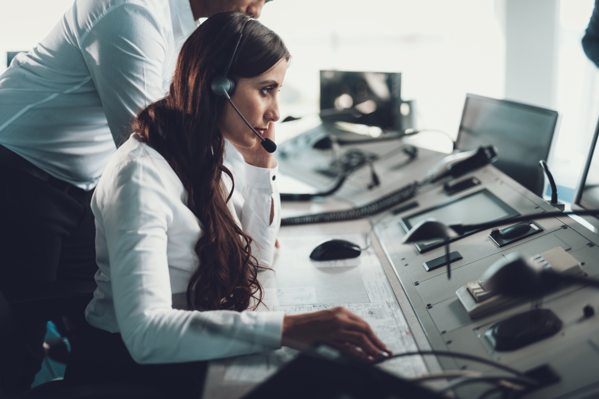 woman wearing a headset at a dispatching station 