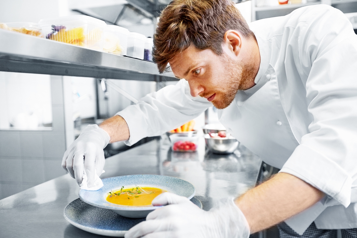 cook preparing a meal in a kitchen