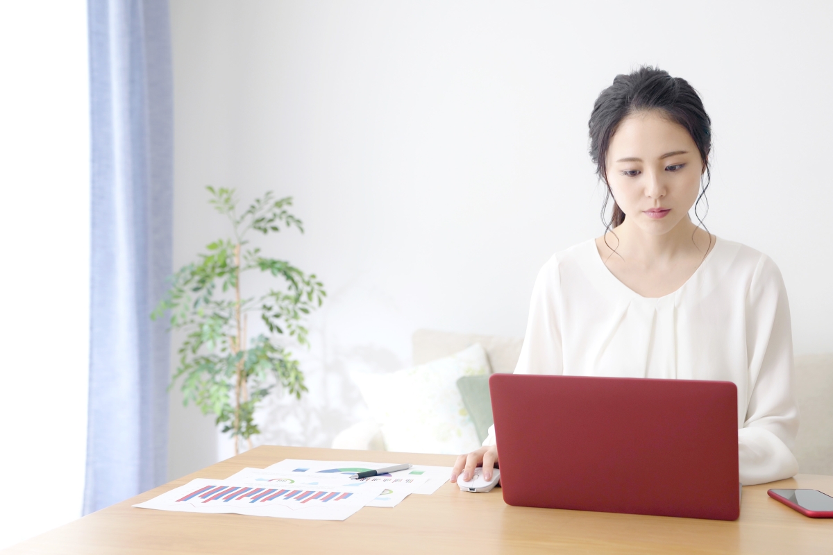 young woman sitting at a desk working on a laptop