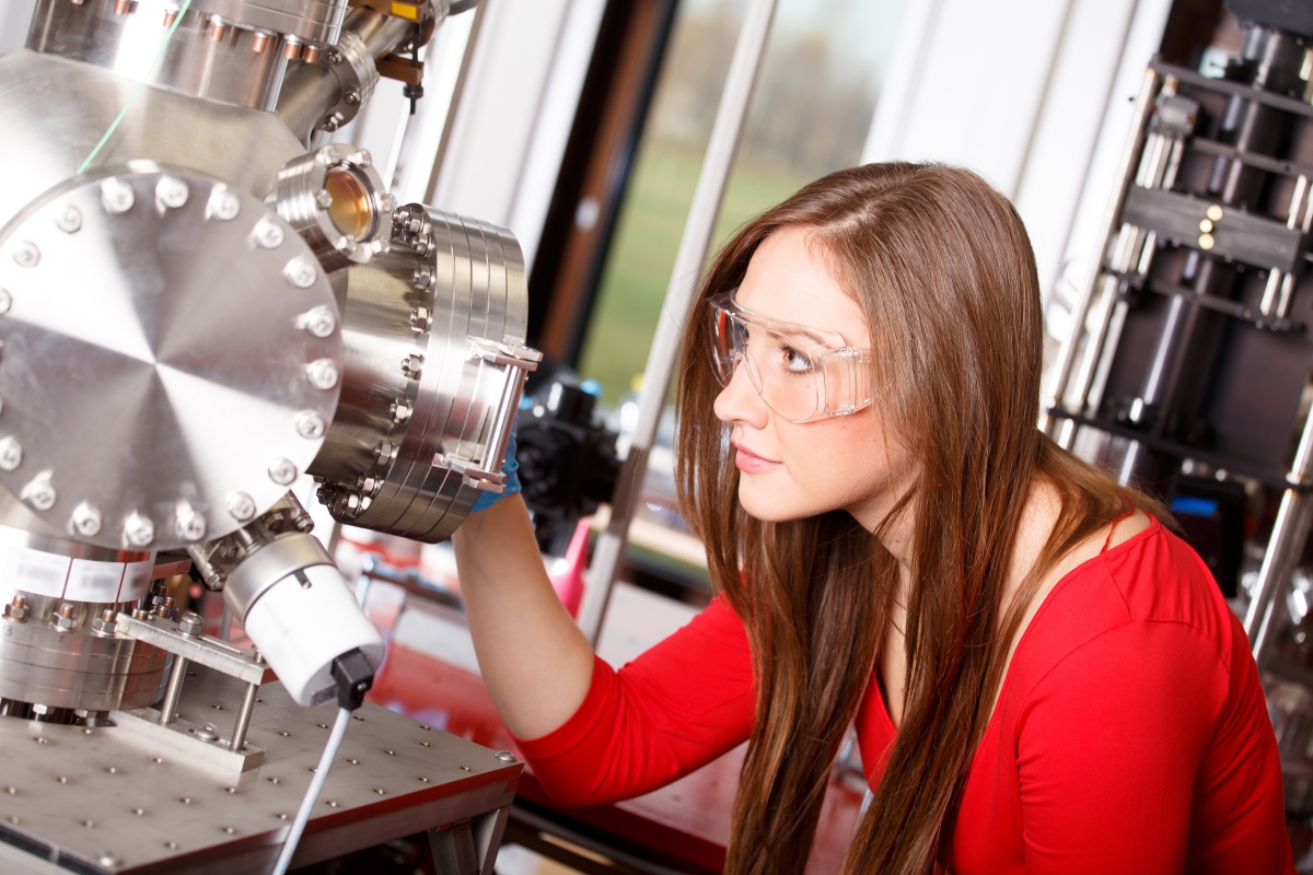 young woman wearing safety glasses in a science lab