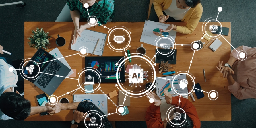 Overhead view of co-working space with overlay of tech icons and the words "AI"
