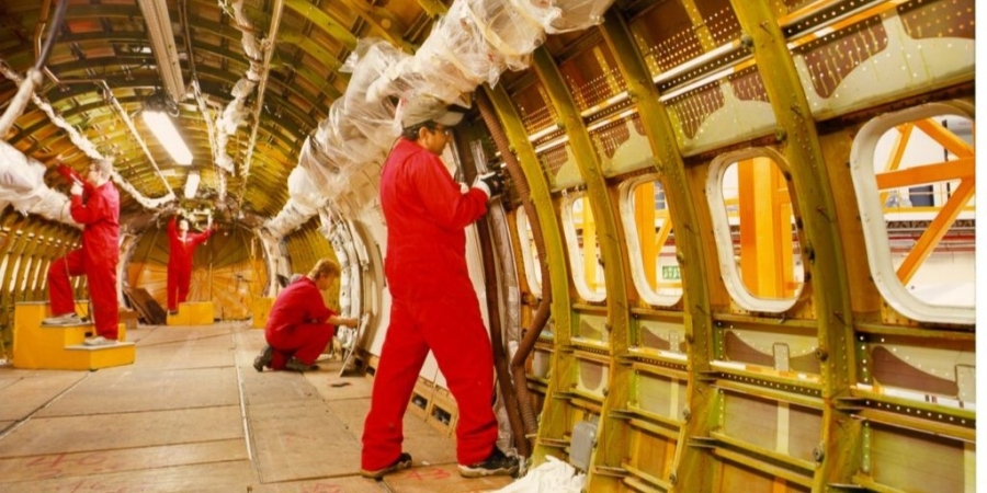 Team of four technicians outfitting the inside of an aircraft