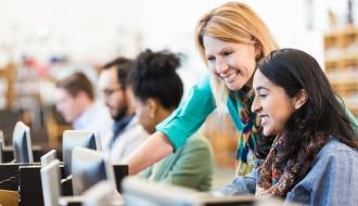 librarian helping female student on a computer